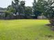 Expansive backyard with lush green grass, mature trees, and privacy fencing at 2707 Canvasback Trail, Myrtle Beach, SC 29588