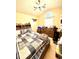 Cozy bedroom with a patterned comforter, unique lighting fixture, and ample storage at 2707 Canvasback Trail, Myrtle Beach, SC 29588