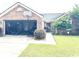Charming single-story brick home with well-manicured lawn, a driveway and a garage at 2707 Canvasback Trail, Myrtle Beach, SC 29588