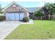 Charming single Gathering house featuring an attached garage, well-manicured lawn, and lovely curb appeal at 2707 Canvasback Trail, Myrtle Beach, SC 29588