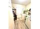 A functional laundry room featuring a washer, dryer, utility sink, and storage shelves at 2707 Canvasback Trail, Myrtle Beach, SC 29588