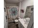 The bathroom features a modern sink and a shower with a floral shower curtain at 297 Harvest Ridge Way, Conway, SC 29527