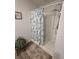 Bright shower with a seashell-themed shower curtain, updated showerhead, and convenient shelving at 297 Harvest Ridge Way, Conway, SC 29527