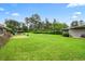 Large, well-manicured backyard featuring lush green grass and mature trees at 316 Oliver St., Marion, SC 29571