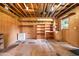 Spacious unfinished basement with exposed ceiling, wooden shelving and concrete floor at 316 Oliver St., Marion, SC 29571