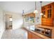 Kitchen area features tile floors, wood cabinets, a bright window, and a built-in cooktop at 316 Oliver St., Marion, SC 29571