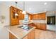 Bright kitchen features wood cabinetry, tile flooring, pendant lighting, and modern cooktop at 316 Oliver St., Marion, SC 29571