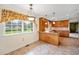 Cozy eat-in kitchen with classic wooden cabinets, tile floor, large window, and pendant lighting at 316 Oliver St., Marion, SC 29571