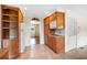 Kitchen with wood cabinets, tile floors, and white appliances, leading to living area at 316 Oliver St., Marion, SC 29571