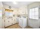 Functional laundry room with sink, washer, dryer, and ample cabinet storage at 316 Oliver St., Marion, SC 29571