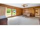 Cozy living room featuring sliding glass doors, a ceiling fan, and wood paneling at 316 Oliver St., Marion, SC 29571