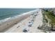Sandy beach with beach goers and gentle waves rolling on the shore at 341 South Dunes Dr. # C-34, Pawleys Island, SC 29585