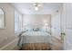Cozy bedroom featuring a queen-size bed, neutral walls, ceiling fan, and mirrored vanity at 341 South Dunes Dr. # C-34, Pawleys Island, SC 29585