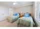 Bright bedroom featuring twin beds with seashell-themed bedding and a glimpse of the en-suite bathroom at 341 South Dunes Dr. # C-34, Pawleys Island, SC 29585