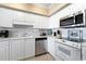 Well-lit kitchen featuring white cabinets, stainless steel appliances and tile flooring at 341 South Dunes Dr. # C-34, Pawleys Island, SC 29585