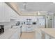 White kitchen featuring ample cabinetry, modern appliances, and a breakfast bar at 341 South Dunes Dr. # C-34, Pawleys Island, SC 29585