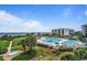 Outdoor swimming pool and sun deck with a tropical landscape at 341 South Dunes Dr. # C-34, Pawleys Island, SC 29585
