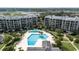 Aerial view of an outdoor swimming pool with sunbathers surrounded by manicured landscaping at 341 South Dunes Dr. # C-34, Pawleys Island, SC 29585
