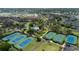 An aerial view of tennis courts next to an outdoor community pool surrounded by landscaped grounds at 341 South Dunes Dr. # C-34, Pawleys Island, SC 29585