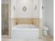 Elegant bathroom featuring a soaking tub, separate shower, and stylish sconces at 346 Tuckers Rd. # A, Pawleys Island, SC 29585