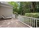 Wooden deck with a chaise lounge overlooking the lush greenery and trees at 346 Tuckers Rd. # A, Pawleys Island, SC 29585