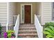 Close-up of the front door featuring brick stairs and white railings leading up to it at 346 Tuckers Rd. # A, Pawleys Island, SC 29585