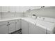 Convenient laundry room equipped with modern washer and dryer units and storage at 346 Tuckers Rd. # A, Pawleys Island, SC 29585