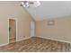 Spacious bedroom with a vaulted ceiling, wood-look flooring, and neutral wall paint at 3700 Golf Colony Lane # 20-L, Little River, SC 29566