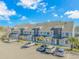 A full exterior shot of townhomes with dedicated parking and trees in an attractive neighborhood at 3700 Golf Colony Lane # 20-L, Little River, SC 29566