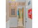 Hallway view leading to bathroom with blue shower curtain, decorative hearts, and neutral tones at 3700 Golf Colony Lane # 20-L, Little River, SC 29566