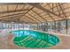 The indoor pool features lots of natural light, lounge chairs, and plenty of space to swim and relax at 3700 Golf Colony Lane # 20-L, Little River, SC 29566