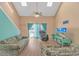 Bright living room with vaulted ceilings, skylights, ceiling fan, and sliding door access to balcony at 3700 Golf Colony Lane # 20-L, Little River, SC 29566