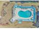 An aerial shot features a kidney-shaped pool with lounge chairs and a deck within a condo community at 3700 Golf Colony Lane # 20-L, Little River, SC 29566