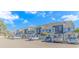 The beautiful townhomes have neutral colored facades with grey roofs and an abundance of parking at 3700 Golf Colony Lane # 20-L, Little River, SC 29566
