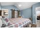 Comfortable bedroom with a plaid bedspread, a barn door to the bathroom, and a ceiling fan at 3833 Myrtle Pointe Dr. # 18 Bu 3, Myrtle Beach, SC 29577