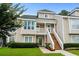 Inviting two-story townhouse with stairs to front porch, well-maintained lawn and landscaped garden at 3833 Myrtle Pointe Dr. # 18 Bu 3, Myrtle Beach, SC 29577
