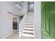 Foyer with white staircase, green front door, light tile and kitchen view at 3833 Myrtle Pointe Dr. # 18 Bu 3, Myrtle Beach, SC 29577