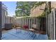 Cozy backyard with a blue rug and chairs, surrounded by a wooden fence, offering a private outdoor space at 403 75Th Ave N # C, Myrtle Beach, SC 29572