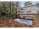 Serene backyard with a wooden fence, chairs on a blue rug, and lush greenery, creating a tranquil outdoor retreat at 403 75Th Ave N # C, Myrtle Beach, SC 29572