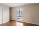 Minimalist bedroom features hardwood floors, a bright window, and neutral wall color, providing a serene retreat at 403 75Th Ave N # C, Myrtle Beach, SC 29572