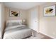 Cozy bedroom with neutral tones, modern art, and a comfortable bed, creating a relaxing atmosphere at 403 75Th Ave N # C, Myrtle Beach, SC 29572