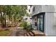 Charming exterior featuring a blue door, brick steps, and landscaped walkway with a view to a fenced backyard at 403 75Th Ave N # C, Myrtle Beach, SC 29572