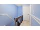 A light blue hallway with wooden bannister and stairs at 403 75Th Ave N # C, Myrtle Beach, SC 29572