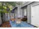 Charming patio area with outdoor seating and a blue striped rug, perfect for relaxing in a private outdoor setting at 403 75Th Ave N # C, Myrtle Beach, SC 29572