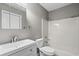 Bathroom featuring a sink, toilet, towel rack, medicine cabinet, and shower-tub combo at 4101 Pinehurst Circle # Aa-3, Little River, SC 29566