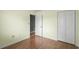 Bedroom with wood-style flooring, view to another room, and closet for storage at 4101 Pinehurst Circle # Aa-3, Little River, SC 29566