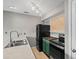 Well-lit kitchen featuring a stainless steel double sink and black appliances at 4101 Pinehurst Circle # Aa-3, Little River, SC 29566