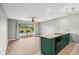 Bright living room with sliding doors to balcony, ceiling fan, and view to kitchen sink at 4101 Pinehurst Circle # Aa-3, Little River, SC 29566