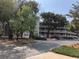 Exterior shot of a condo complex showing parking area, landscaping, and building facade at 415 Ocean Creek Dr. # 2372, Myrtle Beach, SC 29572
