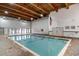 Bright indoor pool area featuring exposed wood beams, a tiled deck, and an American flag at 415 Ocean Creek Dr. # 2372, Myrtle Beach, SC 29572